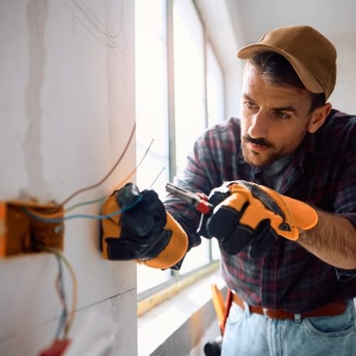 Manual,Worker,Installing,Electric,Cables,At,Construction,Site.,Copy,Space.